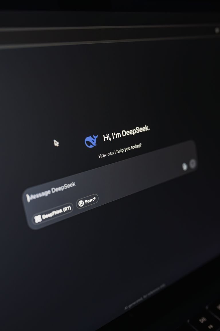 Close-up of a laptop displaying DeepSeek interface with a chatbot prompt in dark mode.