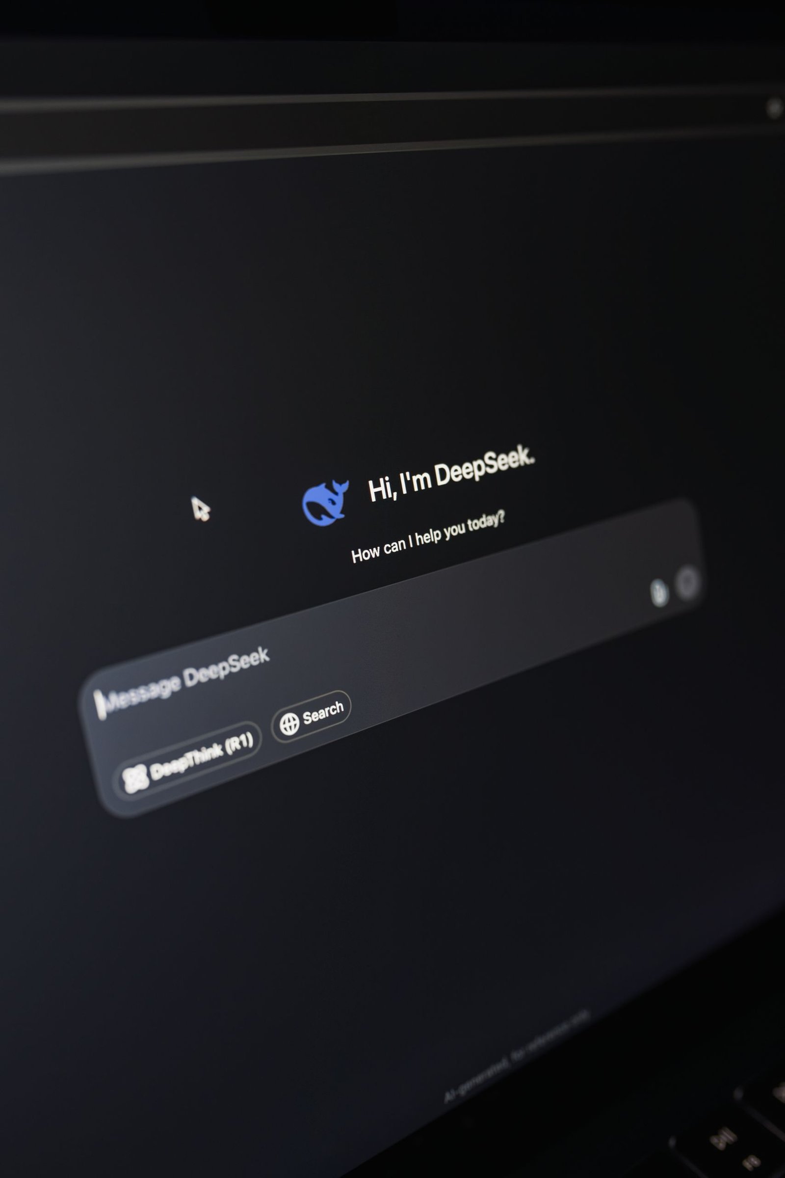 Close-up of a laptop displaying DeepSeek interface with a chatbot prompt in dark mode.